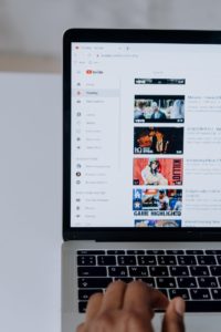 man on computer looking at youtube videos